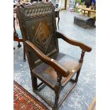 AN 18th.C.AND LATER OAK WAINSCOT CHAIR WITH CARVED CREST RAIL.