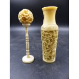 A CHINESE IVORY VASE CARVED IN RELIEF WITH FLOWERS. H.10.5cms TOGETHER WITH A BALL WITHIN BALL