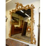 A VICTORIAN ROCOCO REVIVAL GILT AND GESSO OVERMANTLE MIRROR, CARVED AND MOULDED WITH PHOENIX