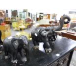 A GROUP OF THREE EASTERN CARVED HARDWOOD FIGURES OF ELEPHANTS. H.32 LARGEST.