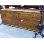 AN UNUSUAL LEATHER UPHOLSTERED AND BRASS MOUNTED FOUR DRAWER LOW CHEST / OTTOMAN. W.140 x H.51 x D.