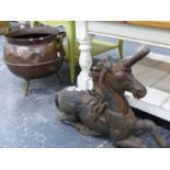 A CAST IRON UNICORN ANDIRON AND AN ARTS AND CRAFTS LIBERTY STYLE COPPER COAL BUCKET.