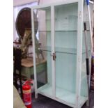 A LARGE MID CENTURY PAINTED METAL FRAMED GLAZED MEDICAL CABINET. W.100 x H.185 x D.45cms.