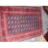 TWO AFGHAN BOKHARA RUGS, LARGEST 181 x 183cms TOGETHER WITH A HOOKED FLORAL RUG. (3)