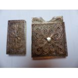 A 19th C. FILIGREE SILVER CARD CASE IN A RED LEATHER CASE, A FURTHER SILVER FILIGREE CARD CASE, A