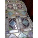 A GROUP OF STAINED GLASS LEADED PANELS.
