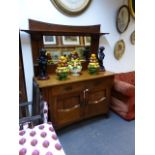 AN ARTS AND CRAFTS OAK MIRROR BACK SIDEBOARD WITH INSET COPPER REPOUSSE PANELS. W.137 x H.200 x D.