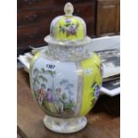 A GERMAN DRESDEN YELLOW GROUND JAR AND COVER, THE FLORAL PAINTED PANELS ALTERNATING WITH FETES