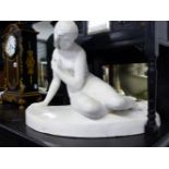 A PLASTER RECLINING FEMALE NUDE.