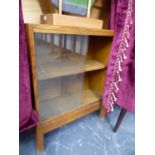 A SMALL OAK ARTS AND CRAFTS BOOKCASE WITH GLASS DOORS. W.57 x H.70 x D.23cms.