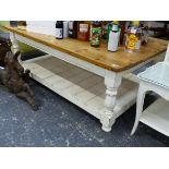 A PINE LARGE COFFEE TABLE ON TURNED LEGS WITH PLANKED LOWER TIER. THE TOP 122 x 77cms H.46cms.