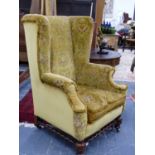 A GOOD ANTIQUE GEO.I.STYLE LARGE WING BACK ARMCHAIR ON TURNED FORELEGS AND BARLEY TWIST STRETCHER.