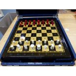 A VINTAGE TRAVELLING GAMES BOX AND CHESS SET.