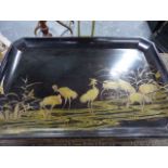 A JAPANESE LACQUER TRAY / STAND DECORATED IN GILT WITH CRANES ON A BLACK GROUND, SHORT SCROLL