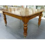 A WILLIAM IV/ EARLY VICTORIAN OAK DRAW LEAF DINING TABLE ON BALUSTER TURNED SUPPORTS WITH BRASS CAPS