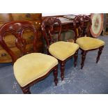 A SET OF SIX VICTORIAN STYLE MAHOGANY BALLOON BACK DINING CHAIRS ON SHAPED REEDED FORELEGS.