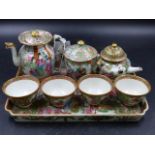 A CANTONESE MINIATURE TEA SET COMPRISING A TRAY, FOUR TEA BOWLS, TEA, COFFEE AND SUGAR POTS WITH