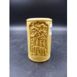 A CHINESE IVORY CYLINDRICAL VASE CARVED WITH TWO RELIEF PANELS OF VILLAGE SCENES SEPARATED BY AN