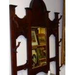 AN OAK ARTS AND CRAFTS MIRROR BACK HAT / STICKSTAND WITH SHAPED CREST ABOVE BEVELLED PLATE AND