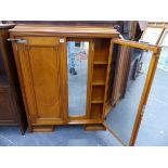 AN UNUSUAL EARLY 20th.C.SATINWOOD SHIP'S CABINET WITH RATCHET MOUNTED DOORS ENCLOSING FITTED MIRRORS