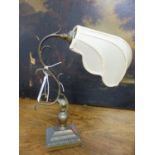 AN EARLY 20th.C.BRASS ADJUSTABLE DESK LAMP WITH SHELL FORM SHADE.