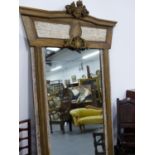 A LARGE LIMED OAK MIRROR WITH CARVED PANEL CREST. 150 x 218cms.
