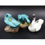 A MEISSEN SWAN. H.7cms TOGETHER WITH A PAIR OF CHINESE TURQUOISE GEESE. H.8cms. (3)
