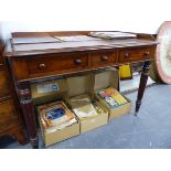 AN EARLY VICTORIAN MAHOGANY WRITING TABLE WITH GALLERY BACK OVER THREE DRAWERS ON REEDED LEGS. W.104