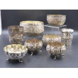 A COLLECTION OF INDIAN AND EASTERN WHITE METAL BEAKERS, COVERED JAR, FOOTED BOWLS, ETC. (8)