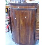 A GEO.III.MAHOGANY BOW FRONT TWO DOOR CORNER CABINET. W.72 x H.109cms.