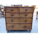 A VICTORIAN MAHOGANY CHEST OF TWO SHORT AND THREE LONG DRAWERS WITH BUN HANDLES ON TURNED FEET. W.