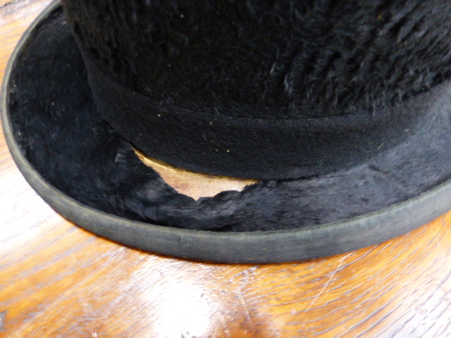 A BLACK TOP HAT BY MOSS BROS IN A CANVAS AND LEATHER HAT BOX, A GREY TOP HAT BY HERBERT JOHNSON