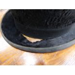A BLACK TOP HAT BY MOSS BROS IN A CANVAS AND LEATHER HAT BOX, A GREY TOP HAT BY HERBERT JOHNSON