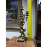 A PAIR OF ANTIQUE FRENCH POLISHED BRASS FOUR LIGHT CANDELABRA WITH SCROLLING BRANCHES WITH MASK