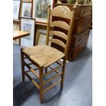 A SET OF SIX RUSH SEAT LADDER BACK DINING CHAIRS.