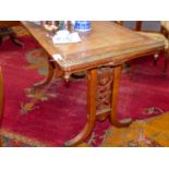 AN EARLY VICTORIAN OAK WRITING TABLE WITH LEATHER INSET SURFACE FLANKED BY PIERCED GALLERY ENDS OVER