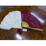AN OSTRICH FEATHER FAN WITH IVORY STAVES TOGETHER WITH A PAINTED SILK FAN. (2)