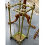 A SMALL VICTORIAN BRASS AND CAST IRON BASE STICKSTAND.