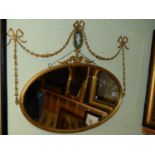 A LATE 19th.C.ADAM REVIVAL OVAL GILTWOOD AND GESSO WALL MIRROR, SWAG SURMOUNT WITH JASPER PLAQUE.