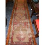 AN ANTIQUE PERSIAN TRIBAL RUNNER. 387 x 95cms.