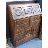 AN UNUSUAL ARTS AND CRAFTS OAK SMALL BUREAU, THE TOP WITH INSET REPOUSSE COPPER PANEL AND PENWORK