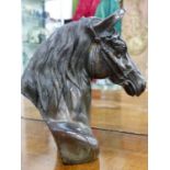 A PATINATED AND WELL DETAILED BRONZE BUST OF A RACEHORSE.