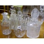 A GROUP OF FIVE VARIOUS CUT GLASS DECANTERS, A PLATED COCKTAIL SHAKER, A TOAST RACK, A PAIR OF BRASS