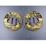 TWO JAPANESE BRONZE AND GILT HIGHLIGHTED SWORD TSUBA DECORATED WITH SAMURAI, EACH WITH CHARACTER