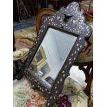 A SYRIAN MOTHER OF PEARL AND METAL INLAID HARDWOOD MIRROR WITH BEVELLED PLATE, LABELLED LIBERTY &