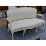 A CARVED AND PAINTED LOUIS XV STYLE SALON SETTEE WITH SHAPED UPHOLSTERED BACK AND SEAT ON CABRIOLE
