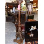 A 19th.C.FRENCH CARVED WALNUT TORCHERE WITH GRIFFIN SUPPORTS. H.155cms.