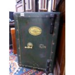 AN ANTIQUE STEEL SAFE COMPLETE WITH KEY. W.40 x H.60 x D.38cms.