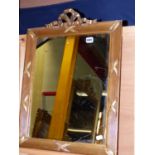 AN ANTIQUE GILT MIRROR IN THE FRENCH TASTE WITH RIBBON CREST. H.66cms.