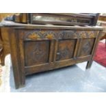 A 17th.C.OAK PANELLED COFFER WITH CARVED FRIEZE AND FRONT PANELS ON STILE SUPPORTS. W.112 x H.60 x